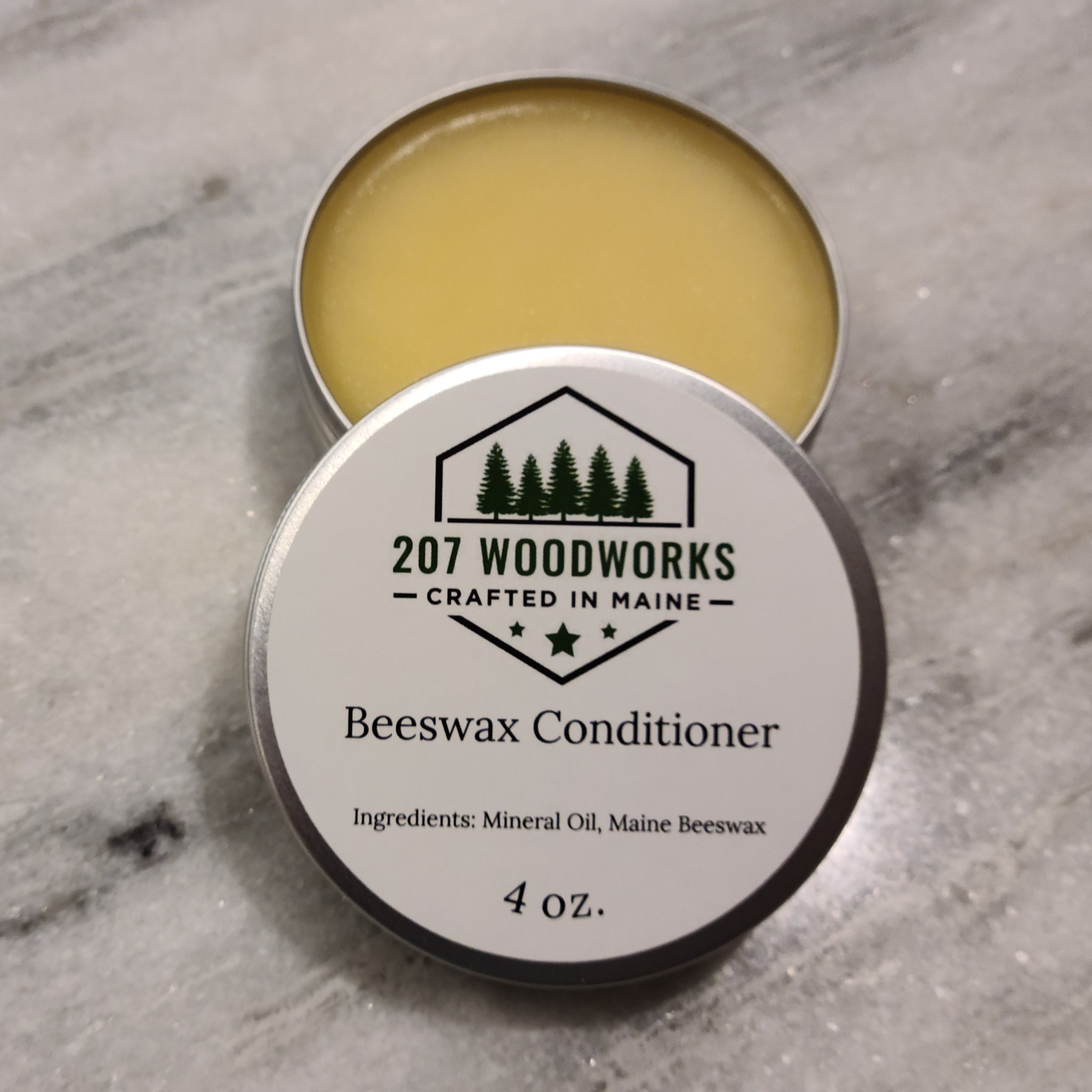 Tins of 207 Woodworks beeswax wood conditioner