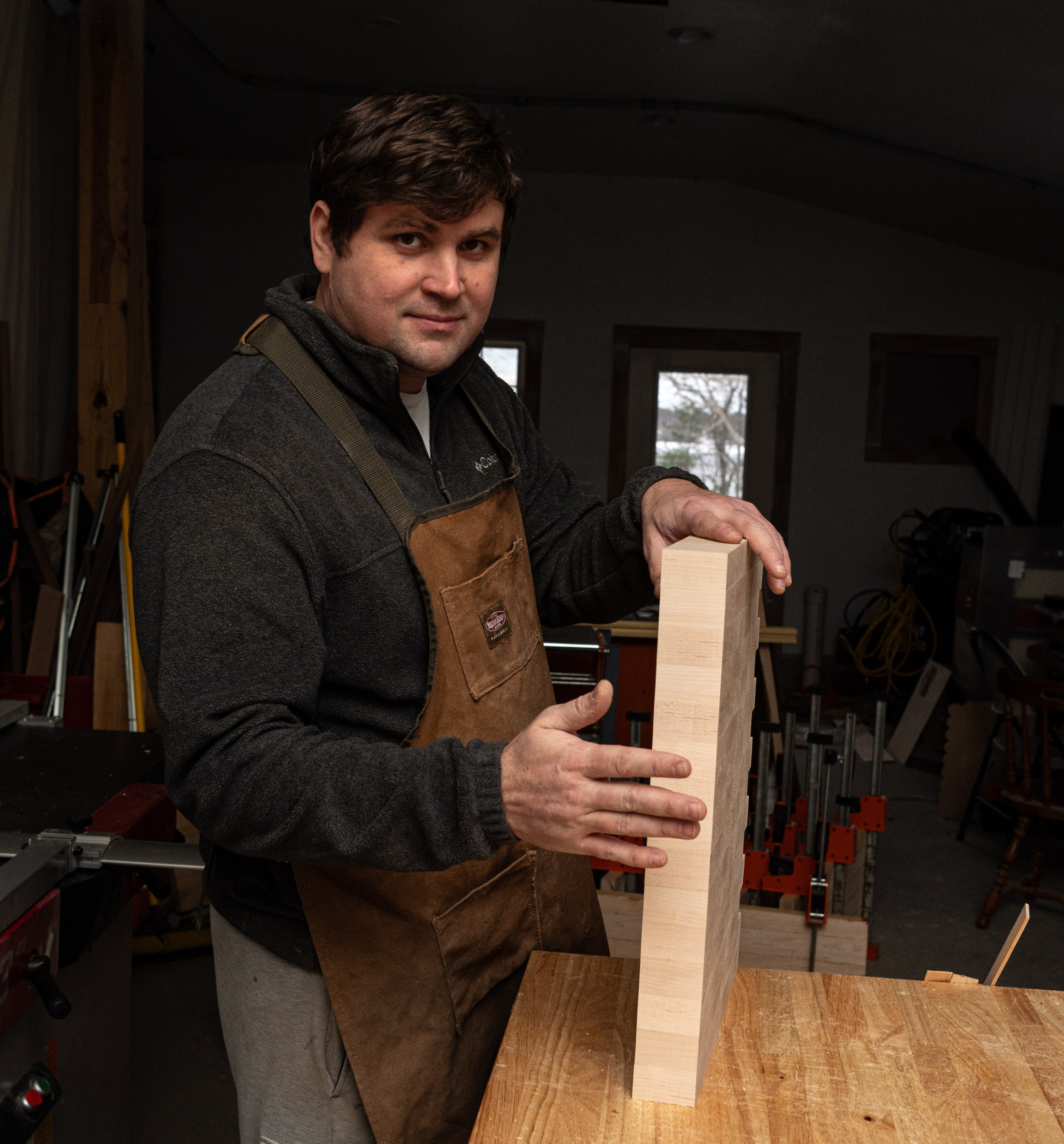 Jonathan Stickney standing at his workbench