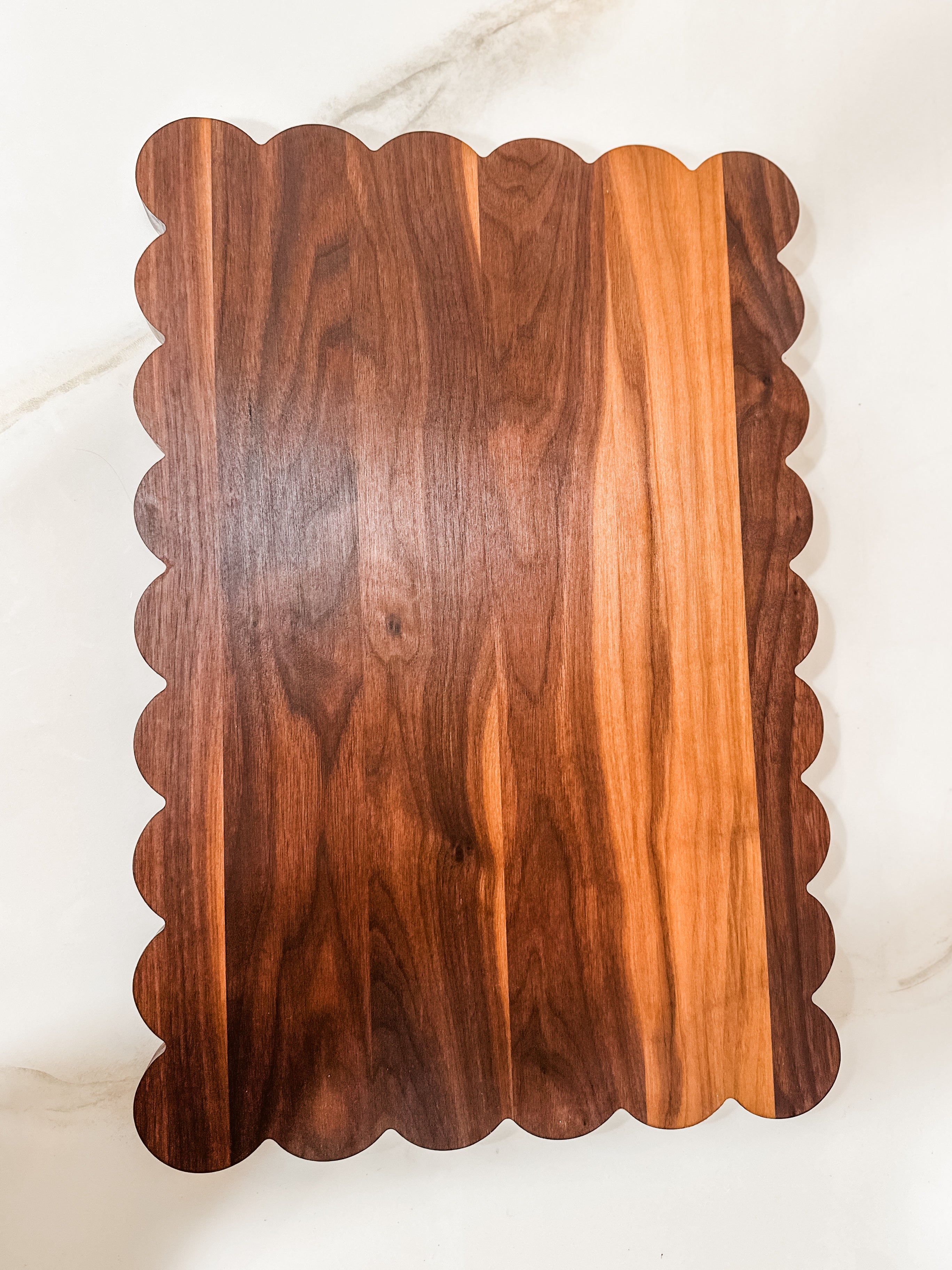 Large white oak cutting board with a scalloped edge
