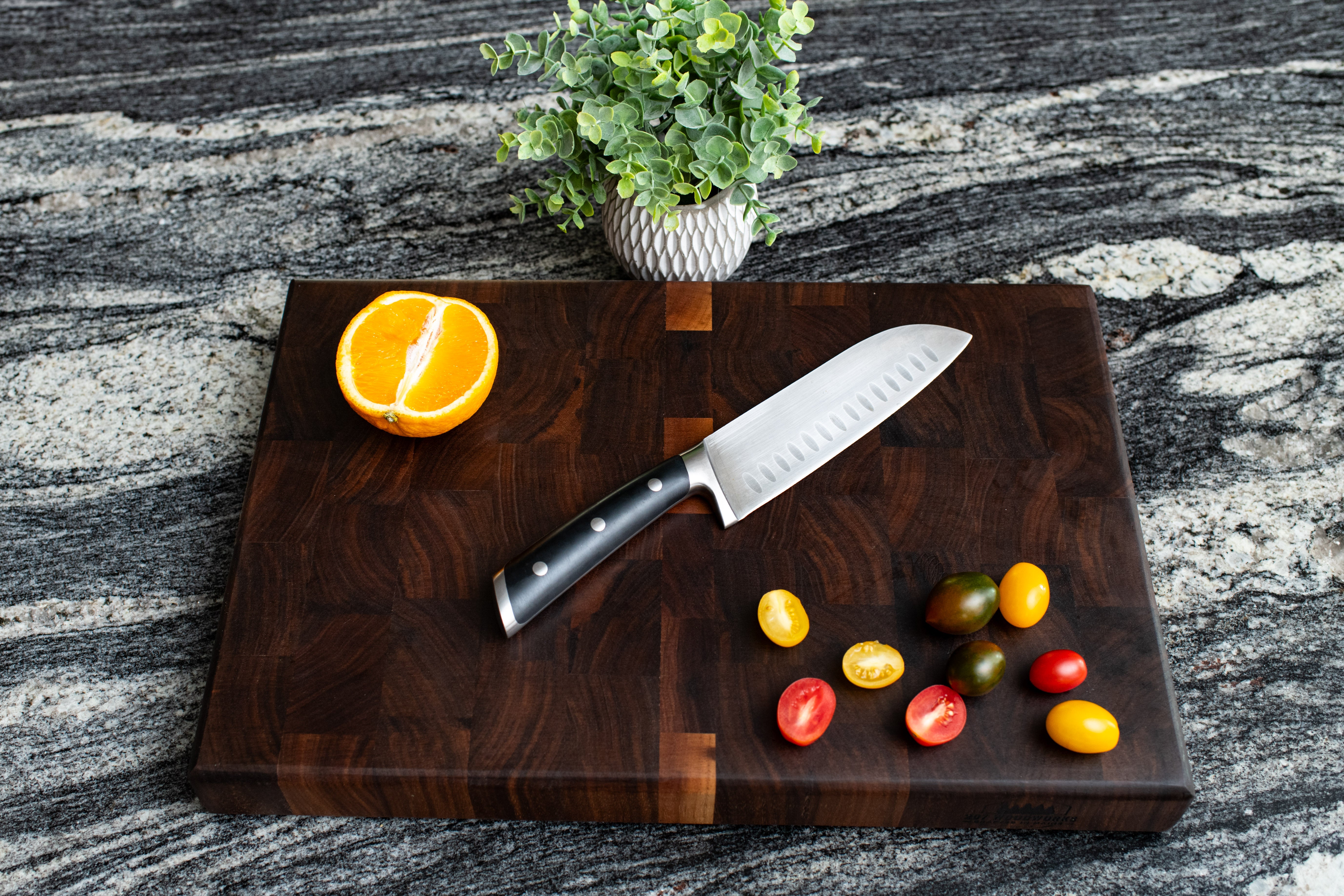 Dark walnut end grain cutting board on a kitchen counter